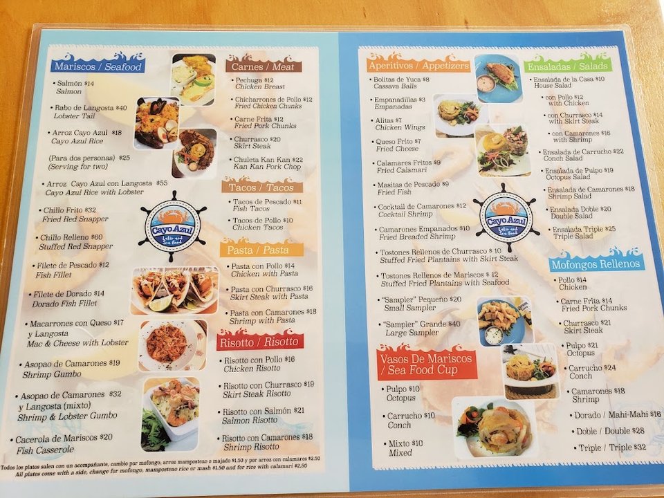Restaurant menu beside a glass of cocktails